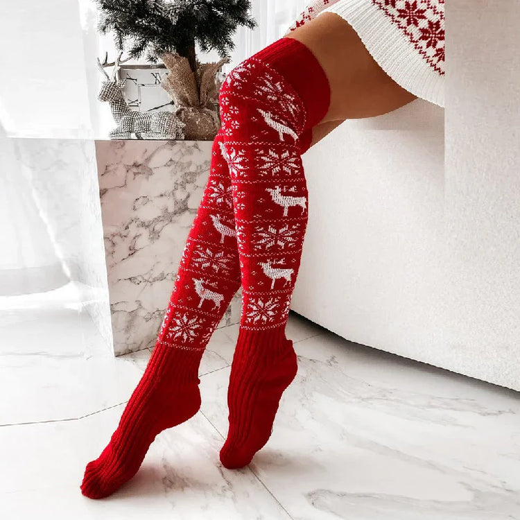 Red knitted over-the-knee socks with white reindeer and snowflake pattern, cozy fit