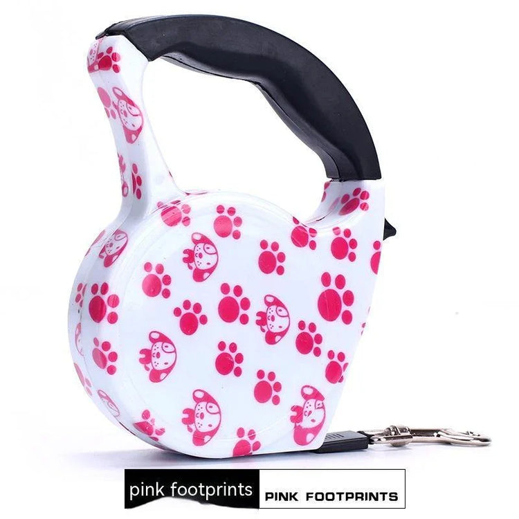 White retractable dog leash with pink paw prints and cartoon dog faces, black handle