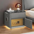 Modern bedside table with gold digital safe, LED lighting, glass top, and lamp in bedroom