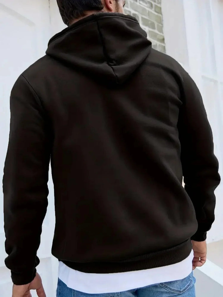 Man wearing a black hooded sweatshirt with relaxed fit and soft fabric, casual streetwear style