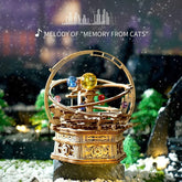 Intricate wooden mechanical model with colorful spheres, displayed on a snowy background