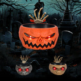 Halloween candy bowls shaped like skulls and pumpkins with glowing red eyes and skeleton hand design