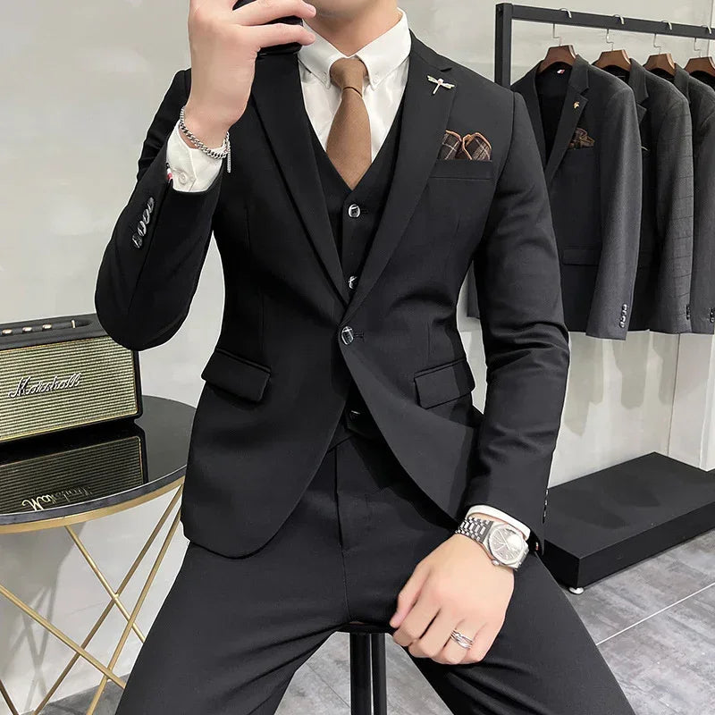 Slim fit black suit with white dress shirt, brown tie, and pocket square, modern formal style