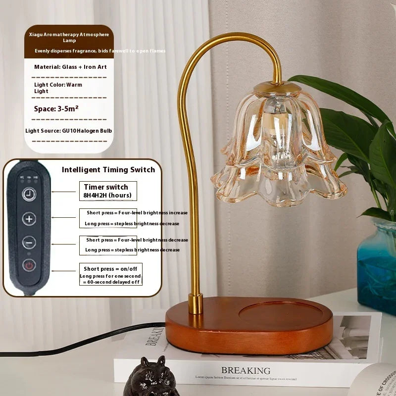 Modern gold and glass flower-shaped aromatherapy lamp with remote control on a wooden base.