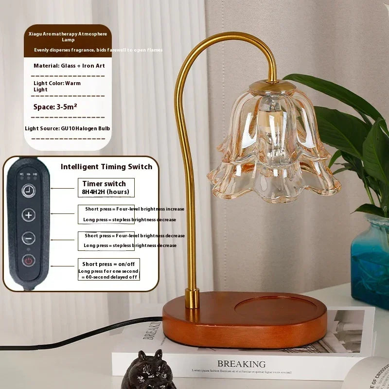 Modern gold and glass flower-shaped aromatherapy lamp with remote control on a wooden base.