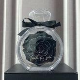 Black preserved rose in clear diamond-shaped case with black ribbon, modern gift decor