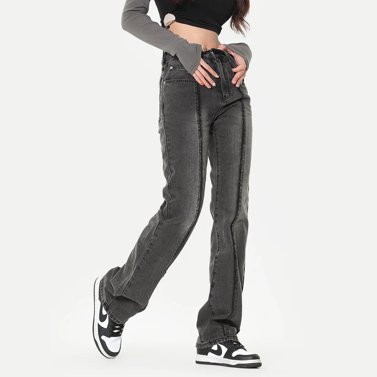 Woman wearing high-waisted straight leg black washed denim jeans with seam detailing