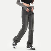 Woman wearing high-waisted straight leg black washed denim jeans with seam detailing