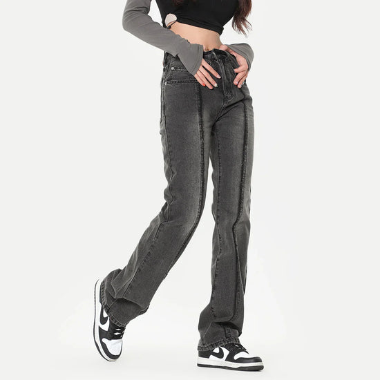Woman wearing high-waisted straight leg black washed denim jeans with seam detailing