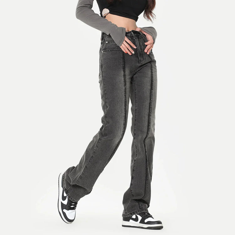 Woman wearing high-waisted straight leg black washed denim jeans with seam detailing