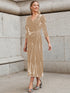 Woman wearing a beige velvet wrap midi dress with puff sleeves and a fitted waist.