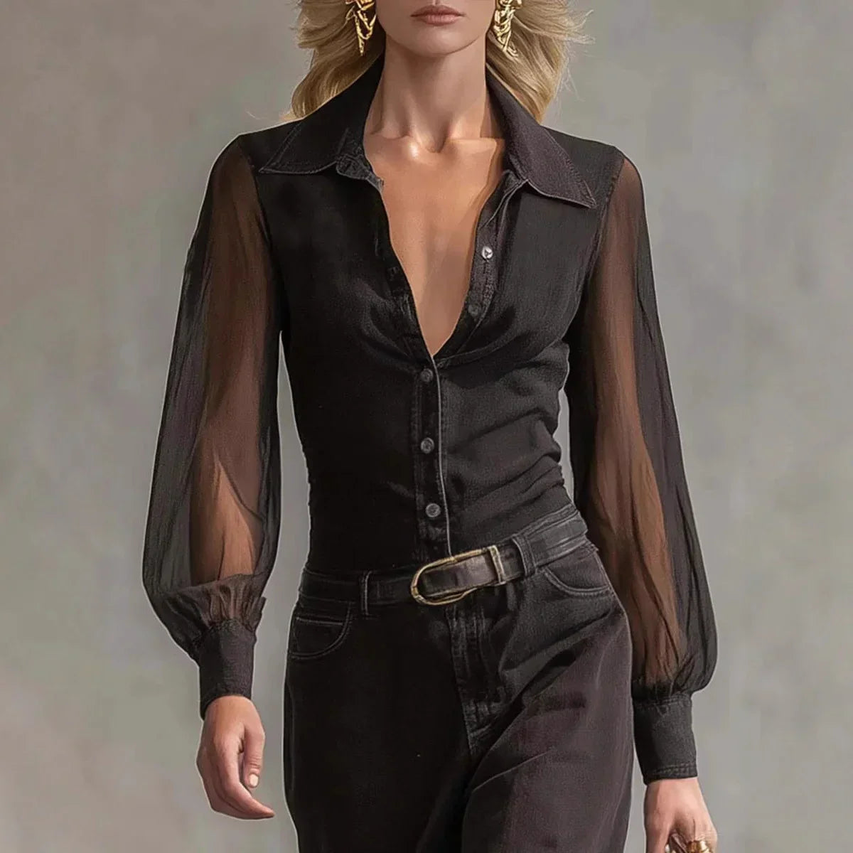 Woman wearing sheer long sleeve black button-up blouse with fitted waist and black pants