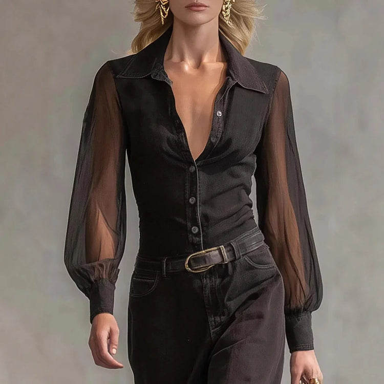 Woman wearing sheer long sleeve black button-up blouse with fitted waist and black pants