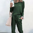 Woman in a green long-sleeve jogger set, relaxed fit, soft fabric, holding a pink tote bag