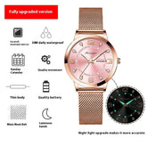 Rose gold mesh strap watch with pink dial, luminous hands, and calendar display