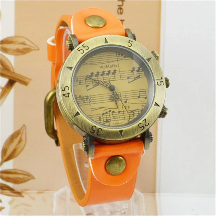 Vintage-style watch with orange leather strap, brass bezel, and musical notes dial design.