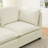 Modern beige fabric sofa with plush cushions and minimalist design in a bright living room