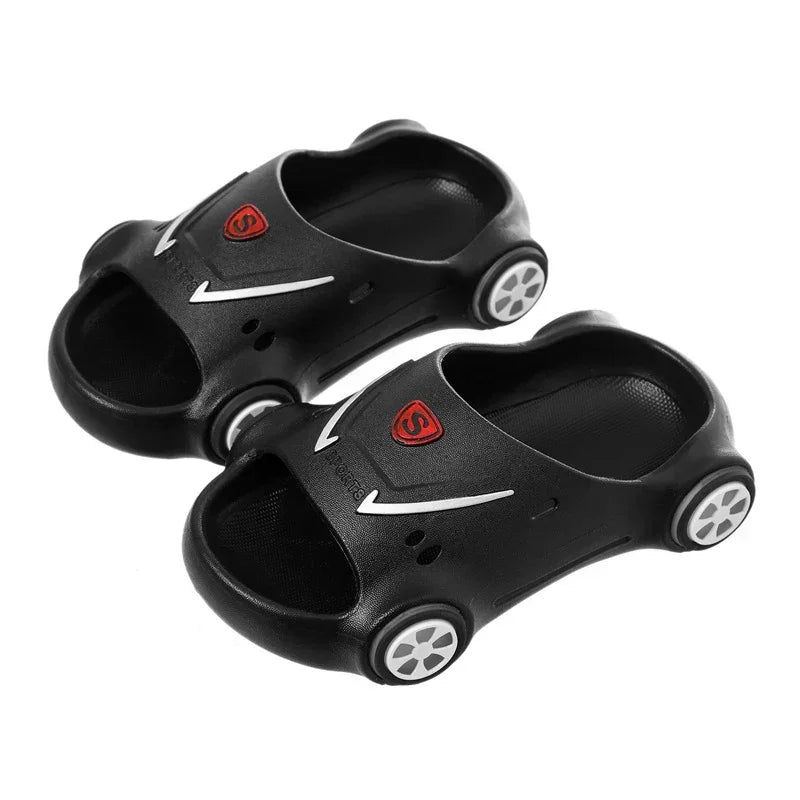 Black car-shaped slide sandals with open toe, white wheel details, and cushioned fit