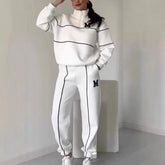 Woman in white relaxed-fit tracksuit with black piping and zip collar, sporty streetwear style