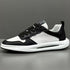 Black and white low top sneaker with mesh and leather material, chunky sole, modern fit