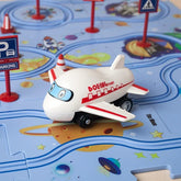 White and red toy airplane on a colorful play mat with cartoon traffic signs and planets.