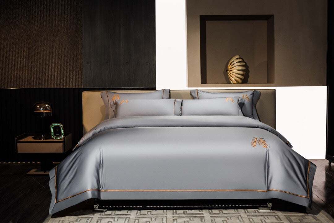 Elegant gray cotton embroidery match sets four-piece bed sheet set on modern bed in stylish bedroom