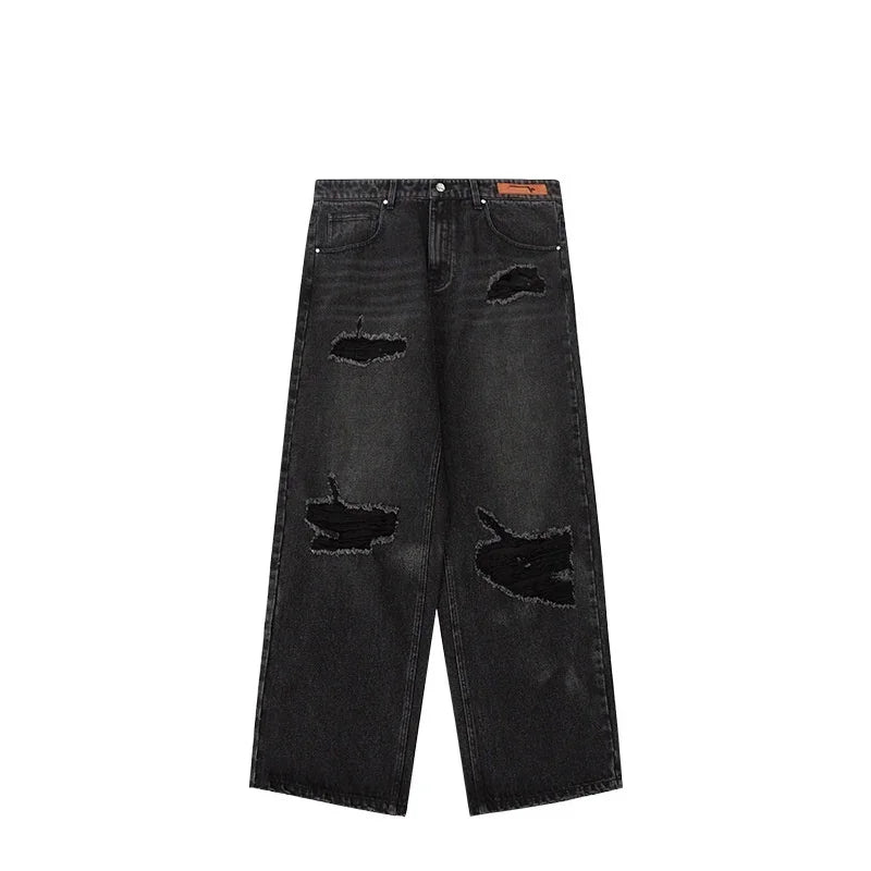 Black wide-leg distressed jeans with ripped details and relaxed fit, streetwear style.