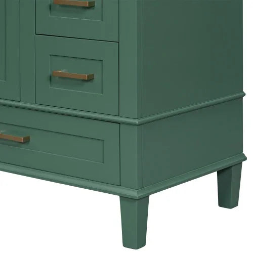 Close-up of green wooden cabinet with gold handles and tapered legs