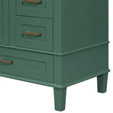 Close-up of green wooden cabinet with gold handles and tapered legs