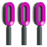Set of three futuristic hair brushes with pink oval heads and black handles