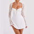 White mini dress with lace long sleeves, fitted bodice, tie front, and flared hem
