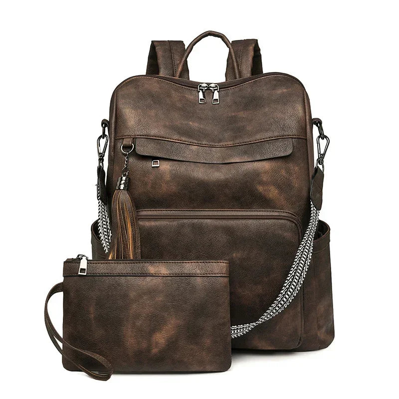 Brown faux leather backpack with zipper pockets and matching wristlet pouch, modern streetwear style