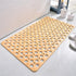 Beige non-slip bath mat with large round holes, soft material, rectangular fit on bathroom floor