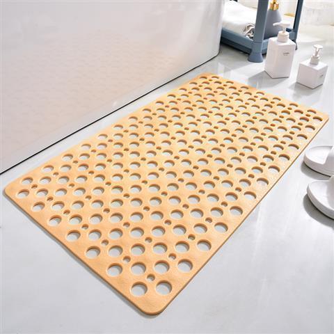 Beige non-slip bath mat with large round holes, soft material, rectangular fit on bathroom floor