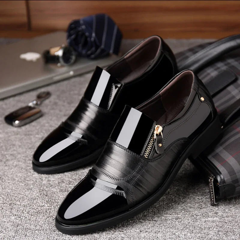 Glossy black leather slip-on dress shoes with zipper detail and pointed toe, modern fit.