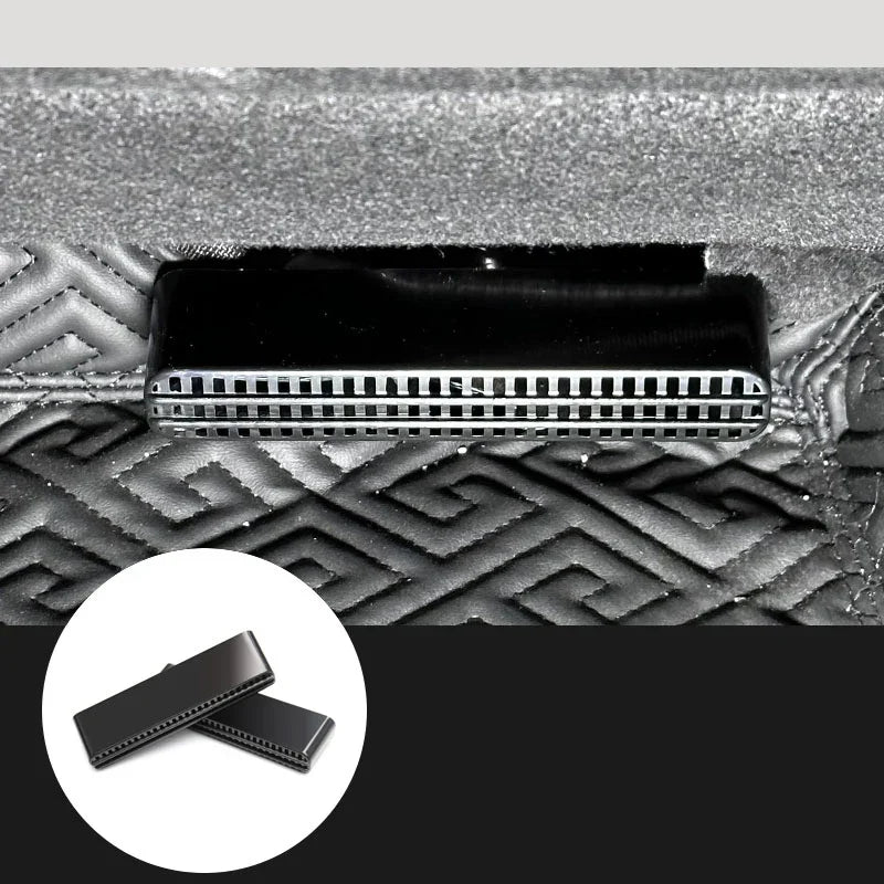 Black metal vent detail on textured geometric-patterned fabric surface
