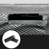 Black metal vent detail on textured geometric-patterned fabric surface