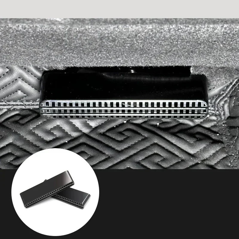 Black metal vent detail on textured geometric-patterned fabric surface