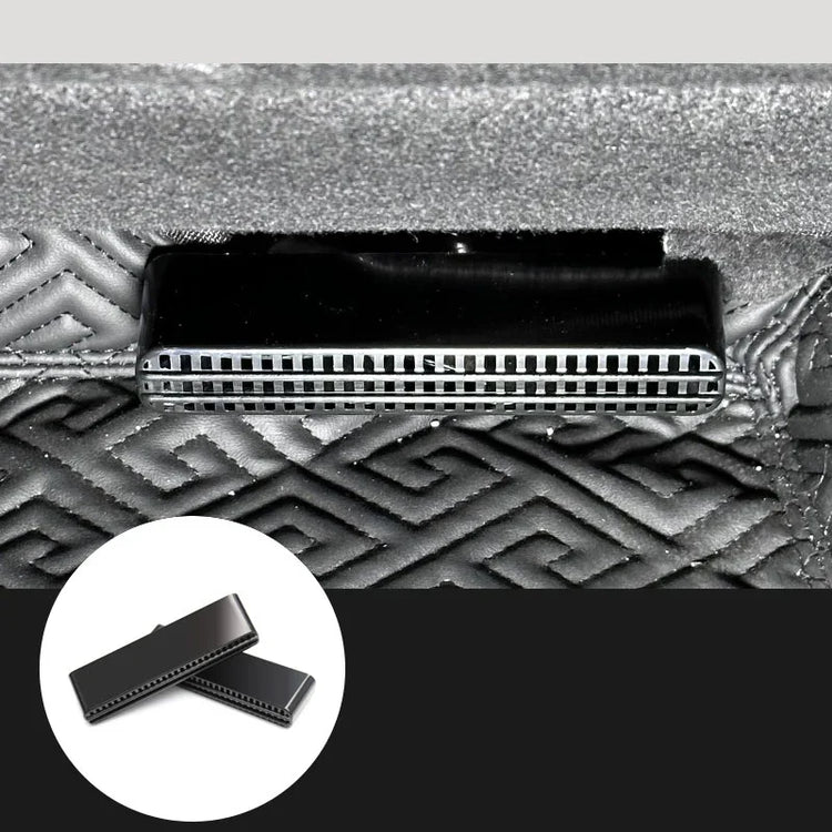 Black metal vent detail on textured geometric-patterned fabric surface