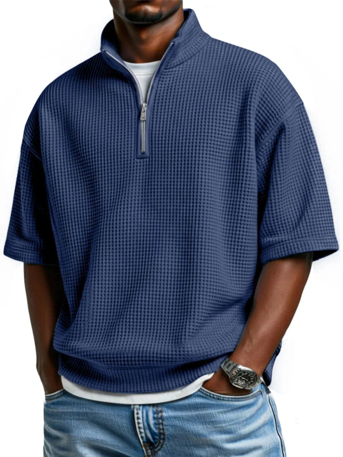 Man wearing blue waffle-textured half-zip shirt with loose fit and casual jeans