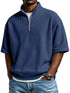 Man wearing blue waffle-textured half-zip shirt with loose fit and casual jeans