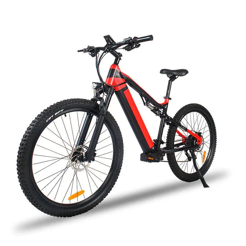 Black and red electric mountain bike with thick tires and front suspension on white background.