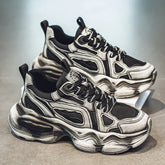 Chunky black and grey futuristic sneakers with mesh panels and thick sculpted soles