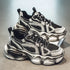 Chunky black and grey futuristic sneakers with mesh panels and thick sculpted soles