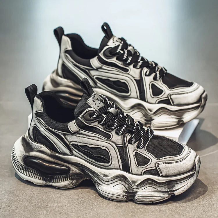 Chunky black and grey futuristic sneakers with mesh panels and thick sculpted soles