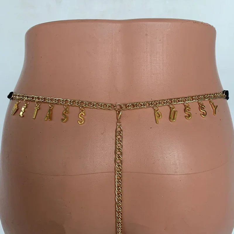 Gold chain waist body jewelry with letter charms and a vertical drop detail, shown on mannequin