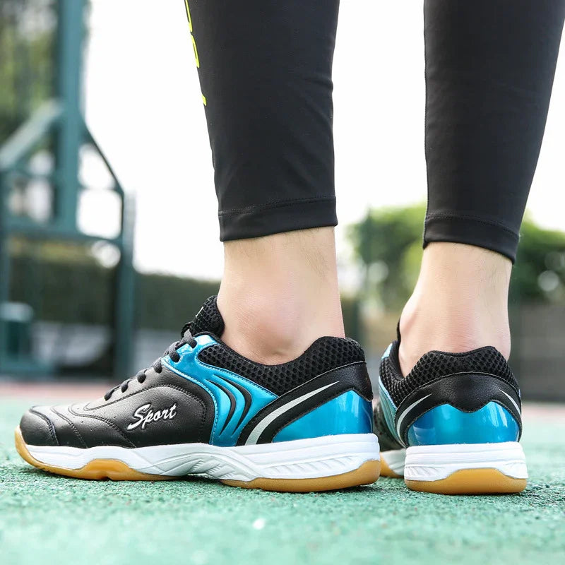Black and blue athletic sneakers with mesh material, rubber sole, sporty fit, outdoor setting