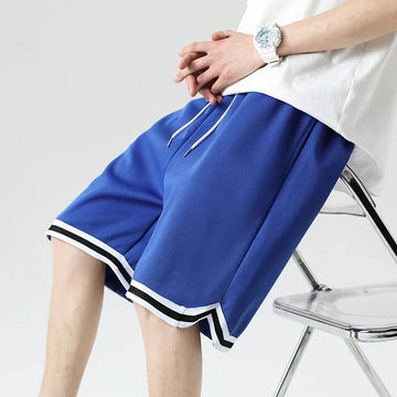 Blue athletic mesh shorts with white drawstring and striped trim, relaxed fit, modern streetwear style.