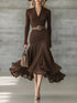 Elegant brown ribbed knit dress with long sleeves, flared skirt, fitted waist, and flowy hem.