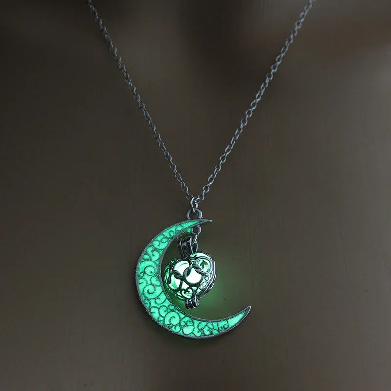 Glow-in-the-dark crescent moon pendant necklace with intricate silver heart design